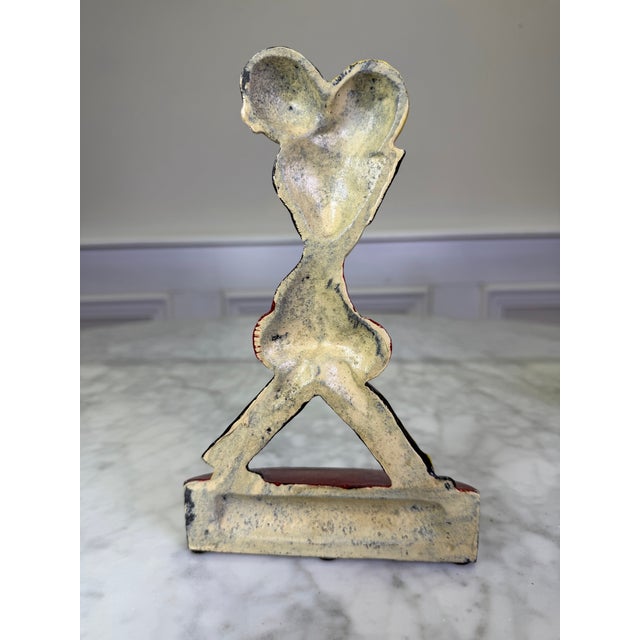 Capture the vibrant energy of the Roaring Twenties with this exceptionally rare and highly sought-after antique cast iron...