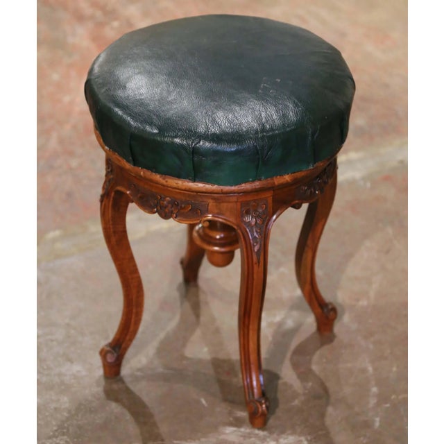 Crafted in Provence, France circa 1880, this elegant antique Louis XV piano stool features a finely carved walnut frame...