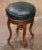 Crafted in Provence, France circa 1880, this elegant antique Louis XV piano stool features a finely carved walnut frame...
