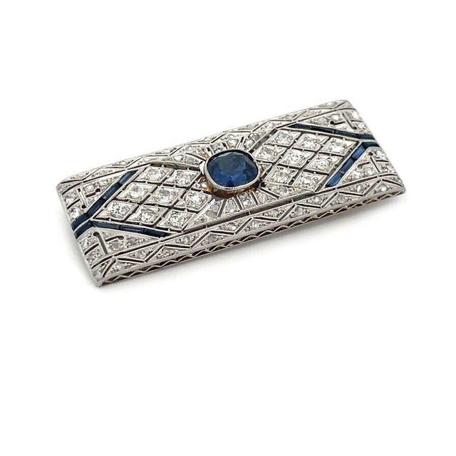 This Art Deco brooch is crafted from platinum top with 18k white gold back and pin. it features a rectangle shape frame...