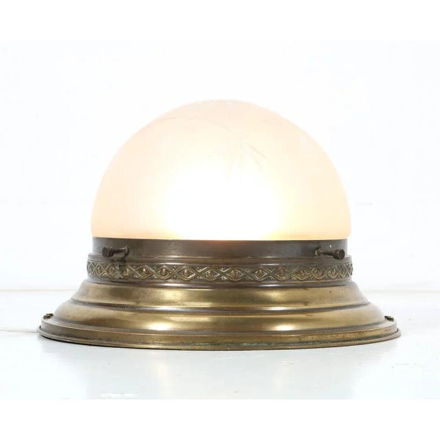 Stunning Art Nouveau flush mount ceiling light. Striking French design from the 1900s. Original patinated brass frame with...