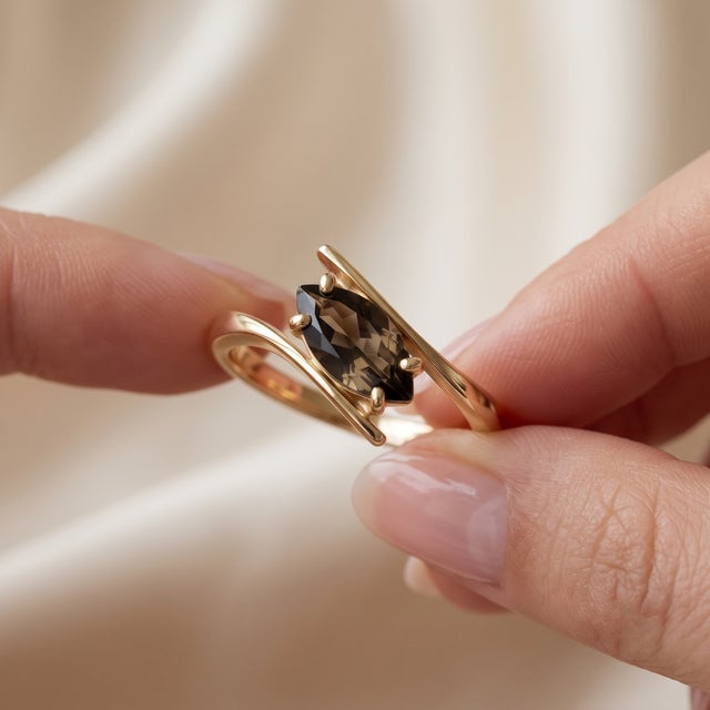 Embrace subtle sophistication with this distinctive bypass ring set with a rich marquise-cut Smoky Topaz (Smoky Quartz)....