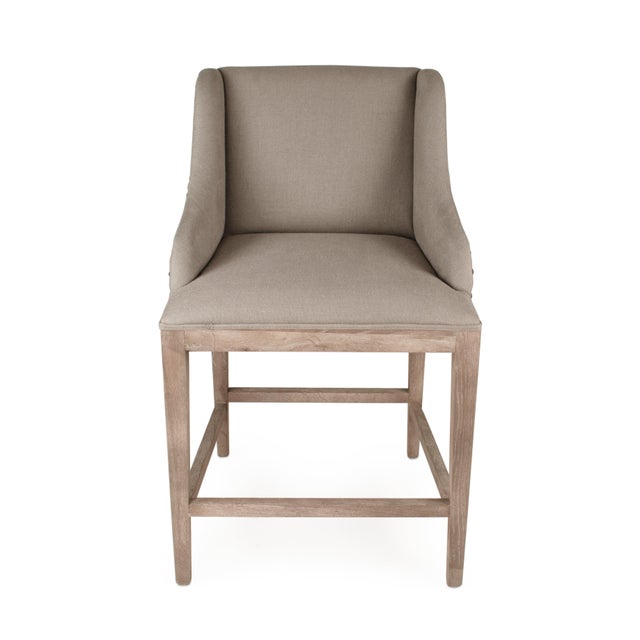 The Connor Counter Stool from Zentique features grey linen upholstery on a limed grey oak frame with straight legs and...