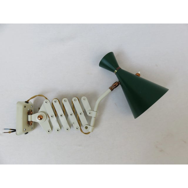 An extremely rare scissor lamp from the 1960s, manufactured by Helo-Leuchten, with an unusual design and typical of the...