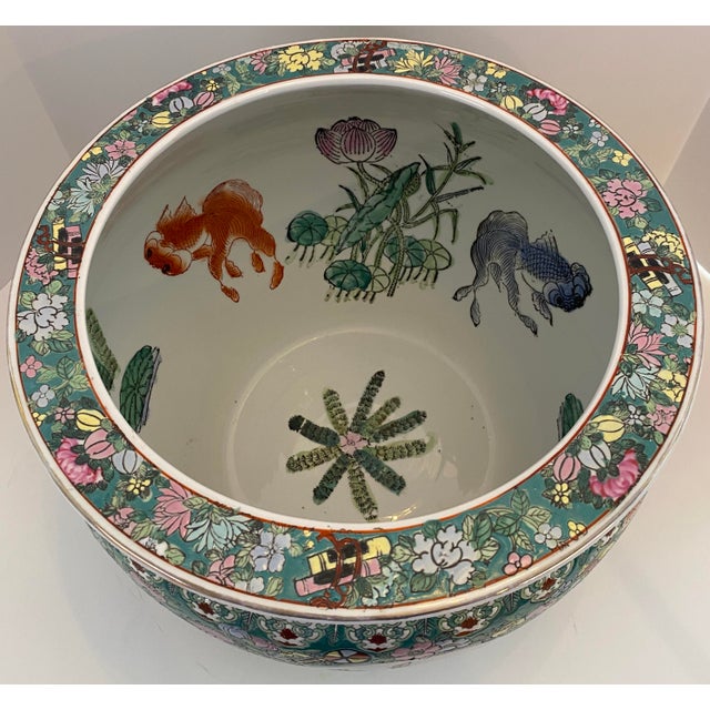 A richly decorated Chinese porcelain fish bowl or jardinière, executed in the famille verte palette and featuring an...