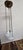 A vintage three-chain frosted glass bowl ceiling light with raised floral decoration and aged metal hardware. The 12-inch...