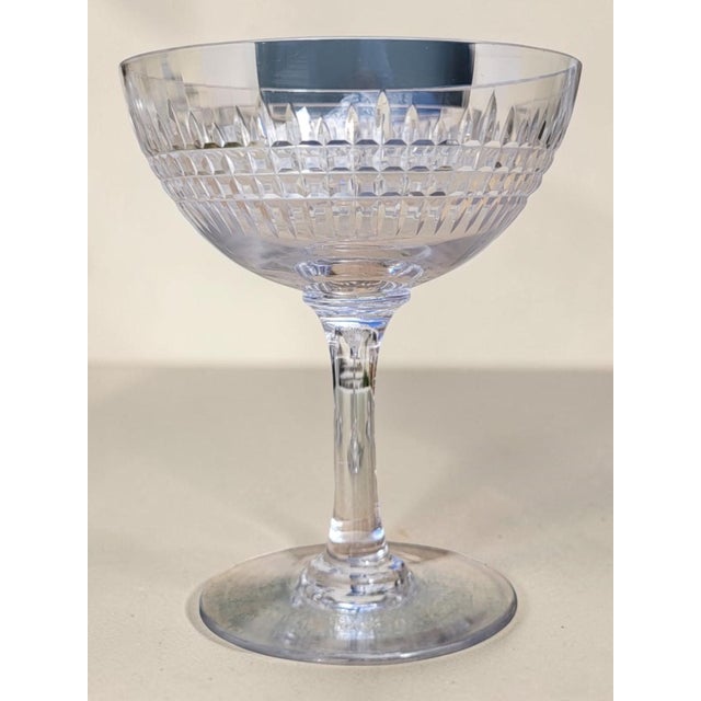 Six cut crystal champagne coupes from the renowned Baccarat crystalworks, in the Nancy pattern. Created in 1867, this...