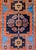 A wonderful early 20th century Persian Karabab rug with a bold tribal pattern containing a large central stylized floral...