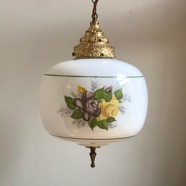A beautiful mid-20th century milk glass floral pendant ceiling light with painted floral motif. This gorgeous vintage...