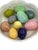 10 colorful hand carved alabaster eggs. Different colors and sizes adorn this cabbage leaf bowl. Some eggs have stickers...