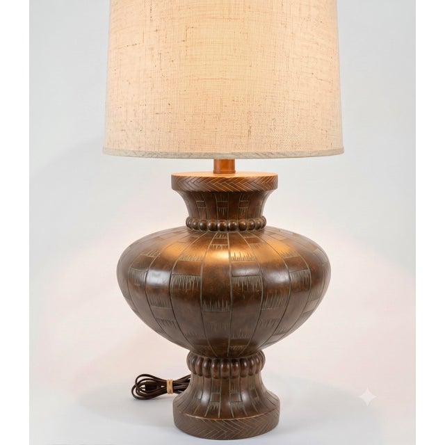 The mid-century table lamp featured here skillfully bridges industrial production and regional craft traditions with such...