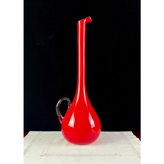 An exceptional 19-inch Mid-Century Italian art glass ewer featuring a dramatic long-neck silhouette, fluid teardrop base,...