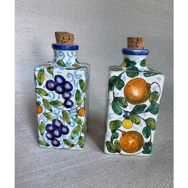 Pair of hand painted Italian ceramic bottles from Tuscany 'Sciroppo de arances' and 'Sciroppo di uva'. Size 6.25 H x 2.5"...