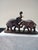 This striking mid-century hand-carved wooden sculpture depicts two stylized fighting elephants locked in motion on an...