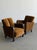 W27 D35.25 H31.5 SW19 SD22.75 SH17.5 AH23.5 A striking pair of Art Deco lounge chairs featuring sculptural dark wood...