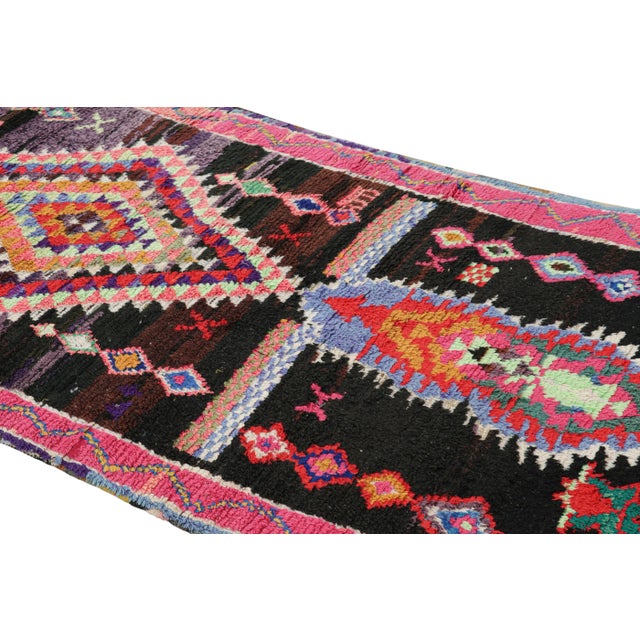 Hand-knotted in wool and originating from Morocco circa 1950-1960, this 4x7 vintage Moroccan rug is an extremely rare...