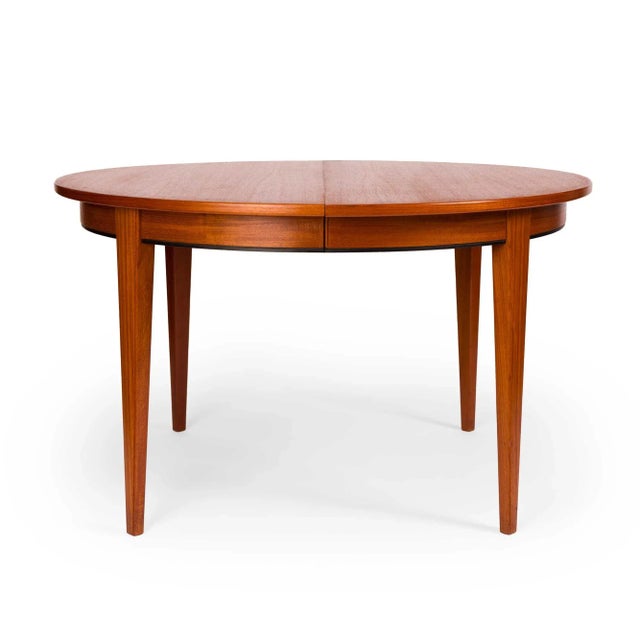This vintage Danish mid-century teak dining table is an iconic design from the 60s. Model #55 was designed and crafted by...