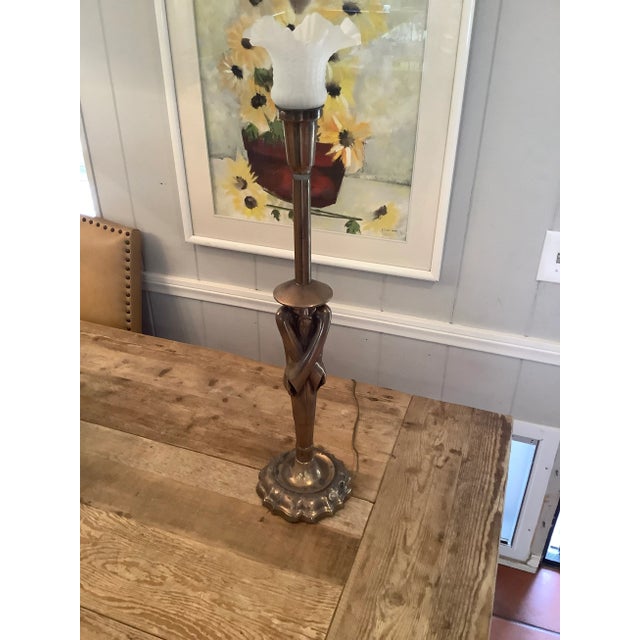 Working table lamp brass base with a chinaman motif with a glass shade. Not sure it’s the original lamp shade