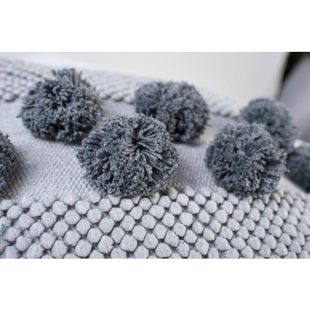 The Pompom Mushroom cover pillow in grey is made of recycled cotton and linen from the waste of home textile products. As...