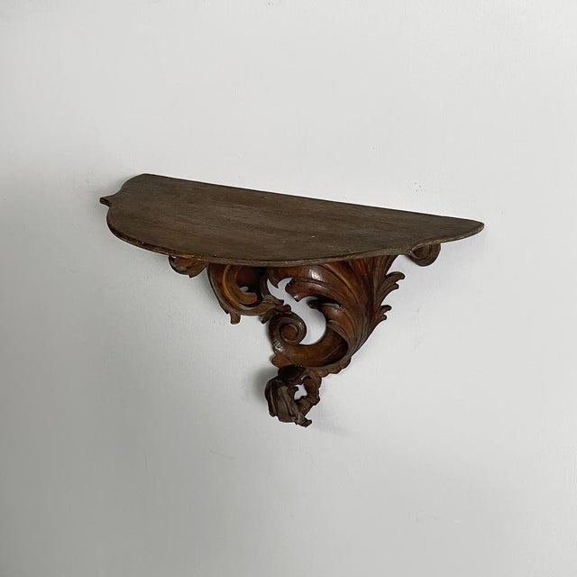 Italian wall shelf in finely crafted wood, 1930s Wall shelf made entirely of wood. The shaped top is supported by a finely...