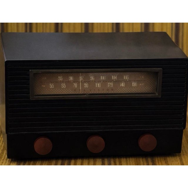 The black Bakelite case exhibits age-appropriate wear and light surface scratches, consistent with its post-war...