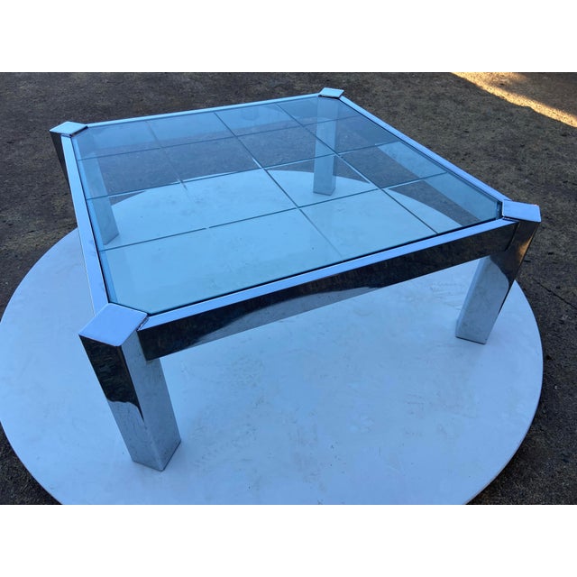 This Vintage Mid Century Modernist Chrome Glass Coffee Table in the Milo Baughman Style exudes a sense of retro charm with...