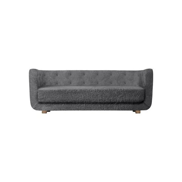 Antrachite sheepskin and smoked oak vilhelm sofa by lassen. Dimensions: w 217 x d 88 x h 80 cm materials: sheepskin, oak....