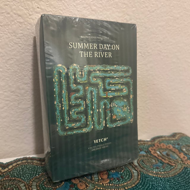 Elevate your game night with this factory-sealed "Summer Day on the River" Majority Edge Piece Puzzle by Yetch Studio....