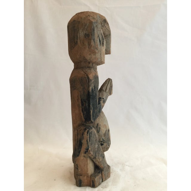 A protective figure from western Nepal. Carved in the namaste gesture of greeting and protection, these figures...
