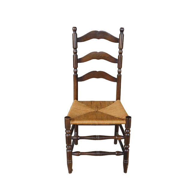 A Charming set of four French Country / Shaker style oak ladder-back dining chairs beautifully showcases the rustic...