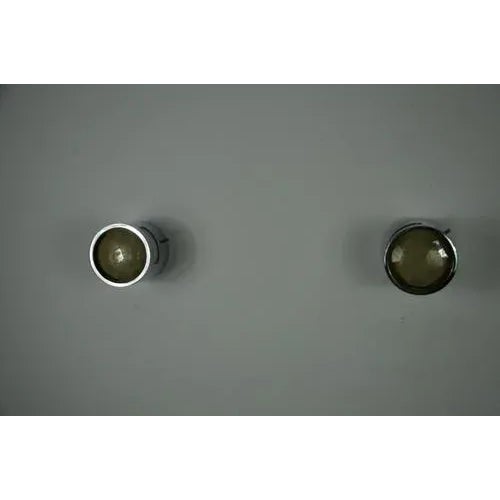 This striking pair of wall lights was designed and produced by veca in italy in the 1960s. Combining polished metal with...