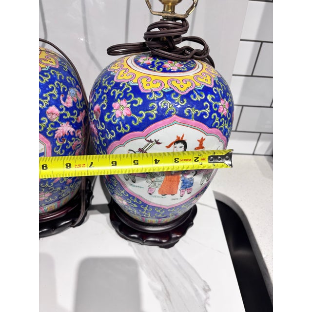 This is a vintage Chinese Famille Rose porcelain jar table lamp featuring a vibrant blue background with intricate floral...