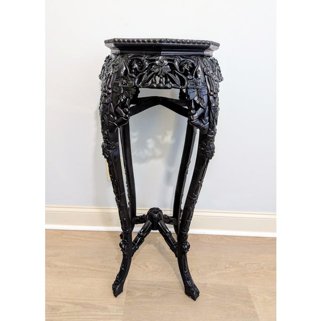This exceptional antique Chinese tall display pedestal features fine hand-carved workmanship dating to the Late Qing...