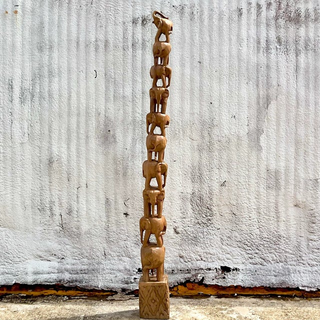 A vintage Boho hand carved elephant stack. A charming totem pol of elephants from the largest at the bottom to the tallest...