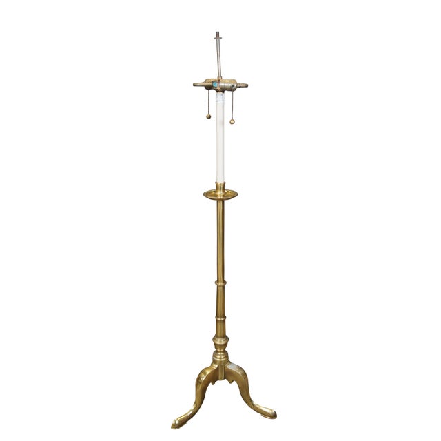 Late 20th century Stiffel two light altar floor lamp featuring a brass tripod / cabriole leg base with faux candlestick...