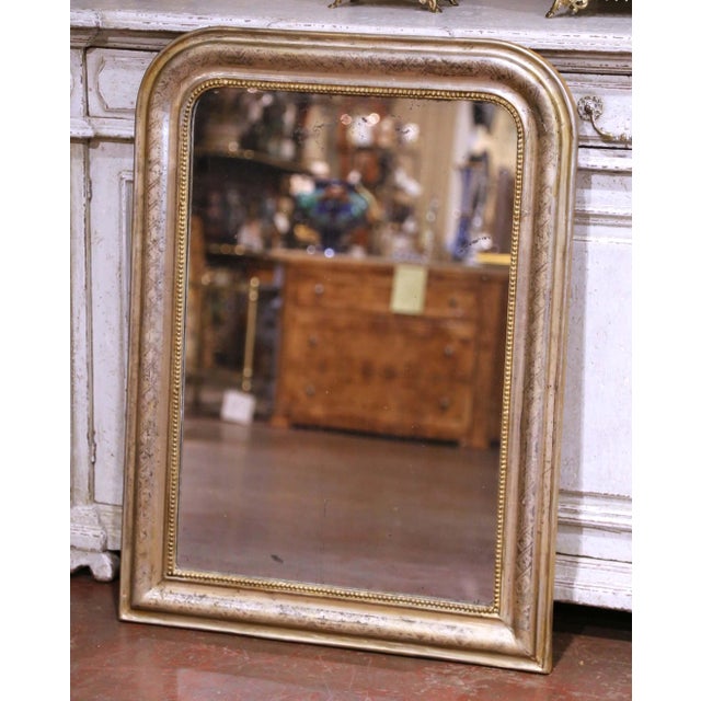 Crafted in France circa 1870, this elegant antique Louis Philippe wall mirror features the classic rounded rectangular...