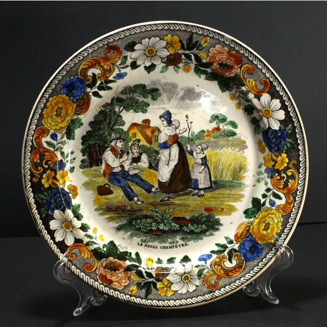 An amazing early French faience plate Intricate and very detailed hand tinted black transfer scene at the center,...