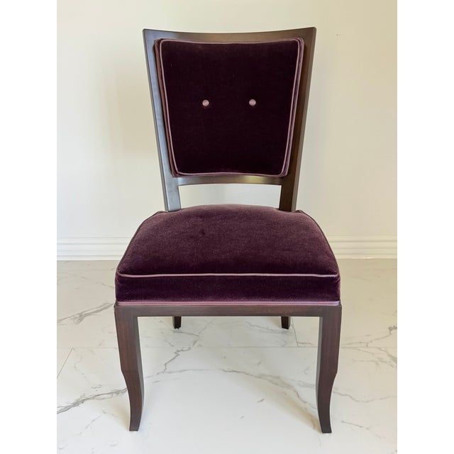 A set of eight dining chairs in the French Modern style, dating to the mid-to-late 20th century. Upholstered in deep...