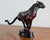 Capture the raw elegance and dynamic energy of the Art Deco era with this exceptional vintage-style bronze charging...