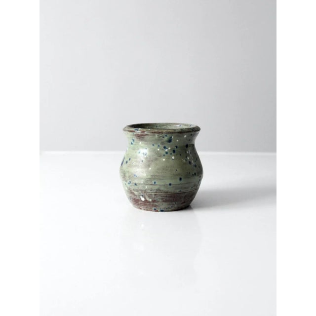 Vintage studio art pottery vase, signed by the artist and beautifully handcrafted with a rich green glaze accented by blue...