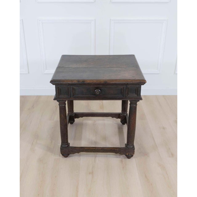 An exceptional 17th century Italian side table crafted from richly aged walnut with remarkable old-world character and...