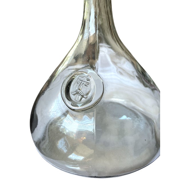 A sculptural mid-century glass decanter designed by Ole Winther for Holmegaard, celebrated for its bold Viking-inspired...