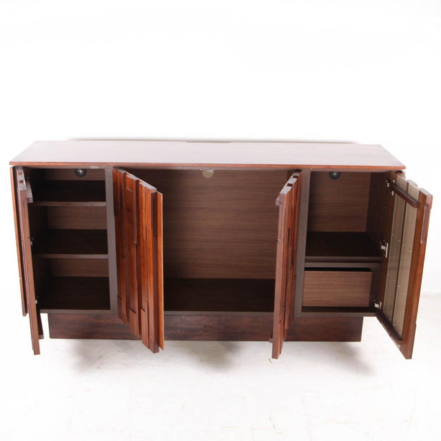 Stunning vintage graphic wooden sideboard with 4 doors Featuring interior shelves and a drawer, this sideboard impresses...