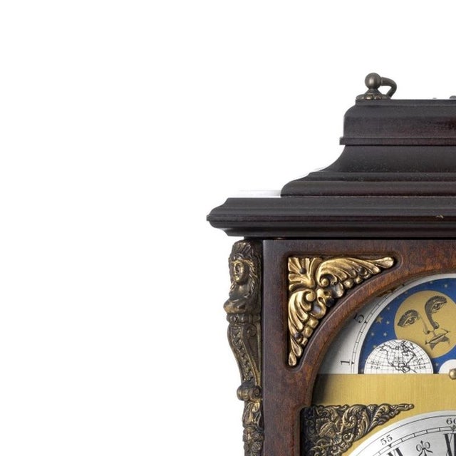 Table clock - Urgos - 19th century. German; 20th century wooden case with gilded metal fittings. Metal dial with Roman...