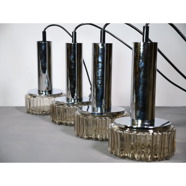 Four space-age ceiling lights by Staff Lighting, Germany, from the 1970s. Chrome-plated fixtures with cylindrical bodies...