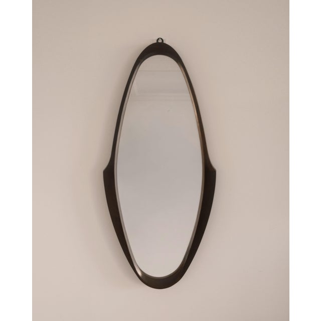Defined by its elongated sculptural frame, this Italian wall mirror transforms a functional object into a carefully...