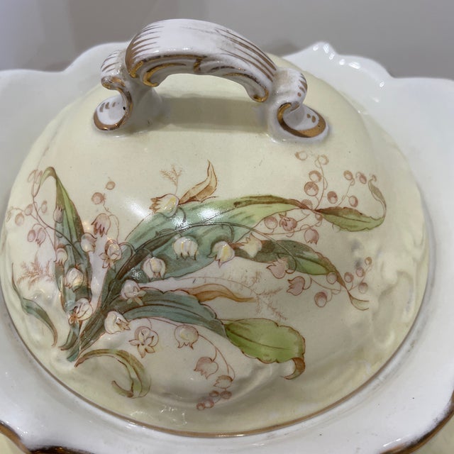 two-handled porcelain vase or covered jar featuring hand painted floral designs, likely from the early 20th century. Due...