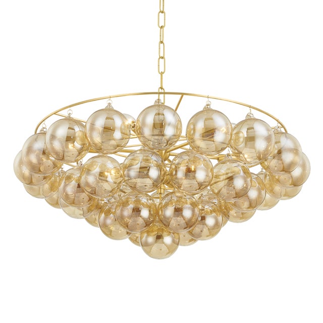 Gorgeous champagne glass globes are clustered around an elegant Aged Brass frame to create a statement piece that is...