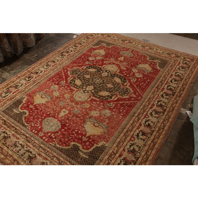 An antique 10x14 rug of the celebrated Turkish Hereke style, hand knotted in wool circa 1920–1930. This particular...