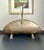 Vintage hammered brass fireplace log holder with cast brass lion heads on the handle brackets and four matching claw feet....